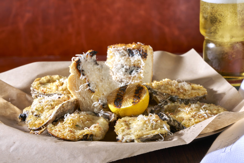 Grilled oysters go great with ice cold draft beer at Tannahill's Tavern. Photo by Kevin Marple.