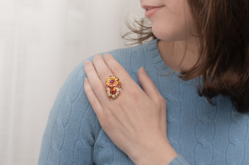 An important estate Breguet 18K yellow gold Bague L'Orangerie bypass flower ring with pavé diamonds, rubies, pink tourmalines, spessartine garnets, yellow sapphires, spinels and one Burmese ruby center. Important due to quality and designer. With box and papers