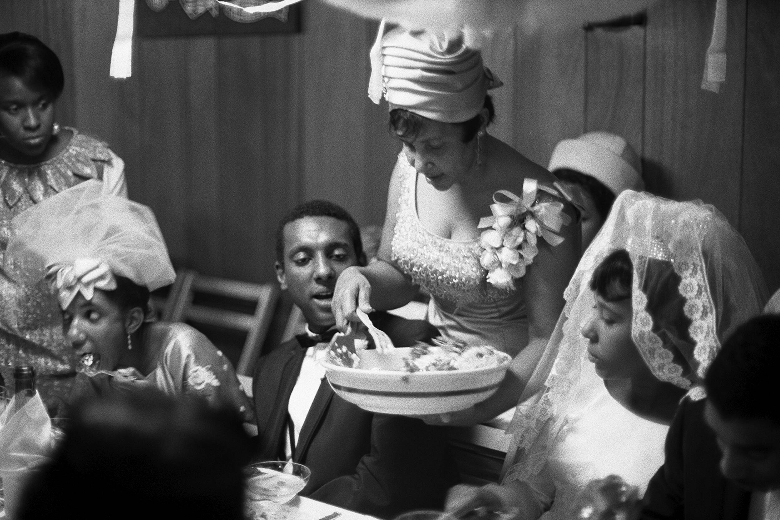 May Charles Carmichael serving her children Lynette and Stokely at Lynette's wedding dinner in the Bronx, 1966. (Caption courtesy Lisa Volpe, MFAH. Photo by Gordon Parks, courtesy The Gordon Parks Foundation.)