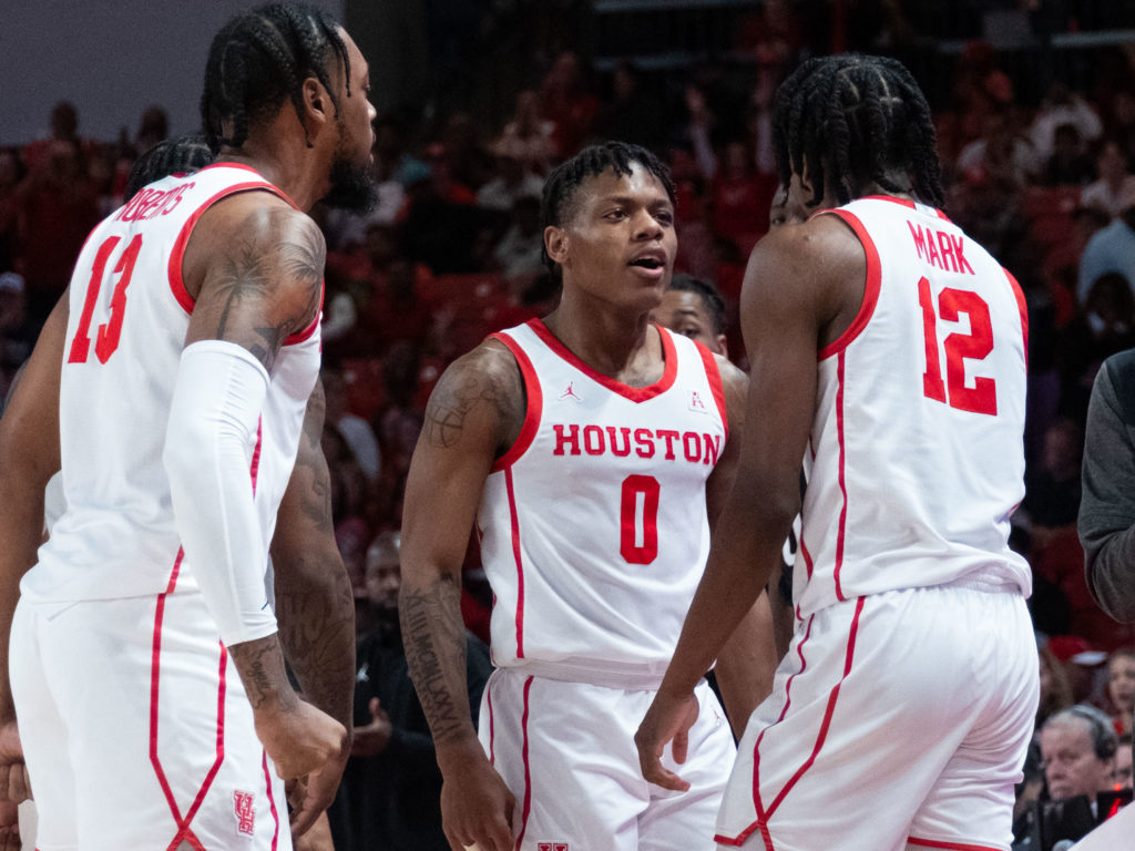 J'Wan Roberts, Marcus Sasser and Tramon Mark pump each other and their UH teammates up. (Photo by F. Carter Smith)