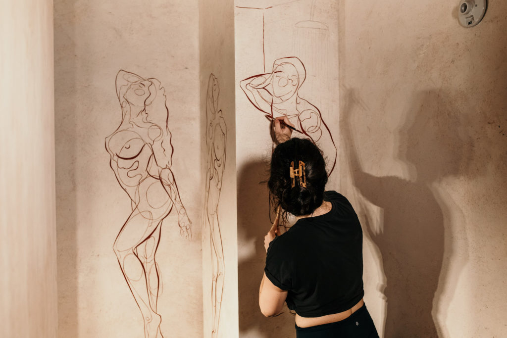 Artist Haley Bowen creates a mural for the latest restaurant by The Big Vibe Group in the Montrose Collective. (Photo by Kirsten Gilliam)