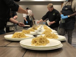 A  view of the kitchen at last year’s Chefs for Paws event. Collaborating chefs work to put out a memorable multi-course meal.