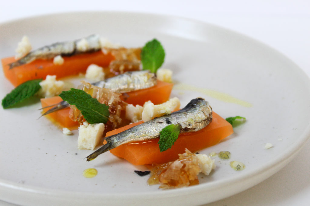 Compressed melon plated with honeycomb, cotija cheese, and anchovy. (Photo by Mary Whitten)