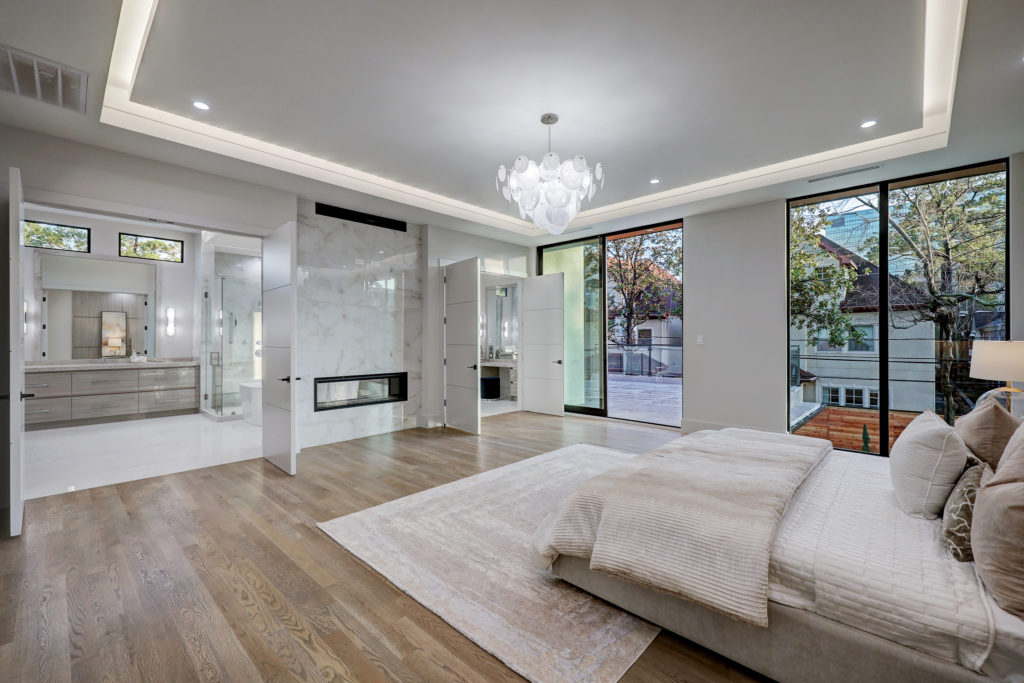 The double-sided fireplace at 275 Pine Hollow Lane heats both the master suite and master bath. (Photo by TK Images)
