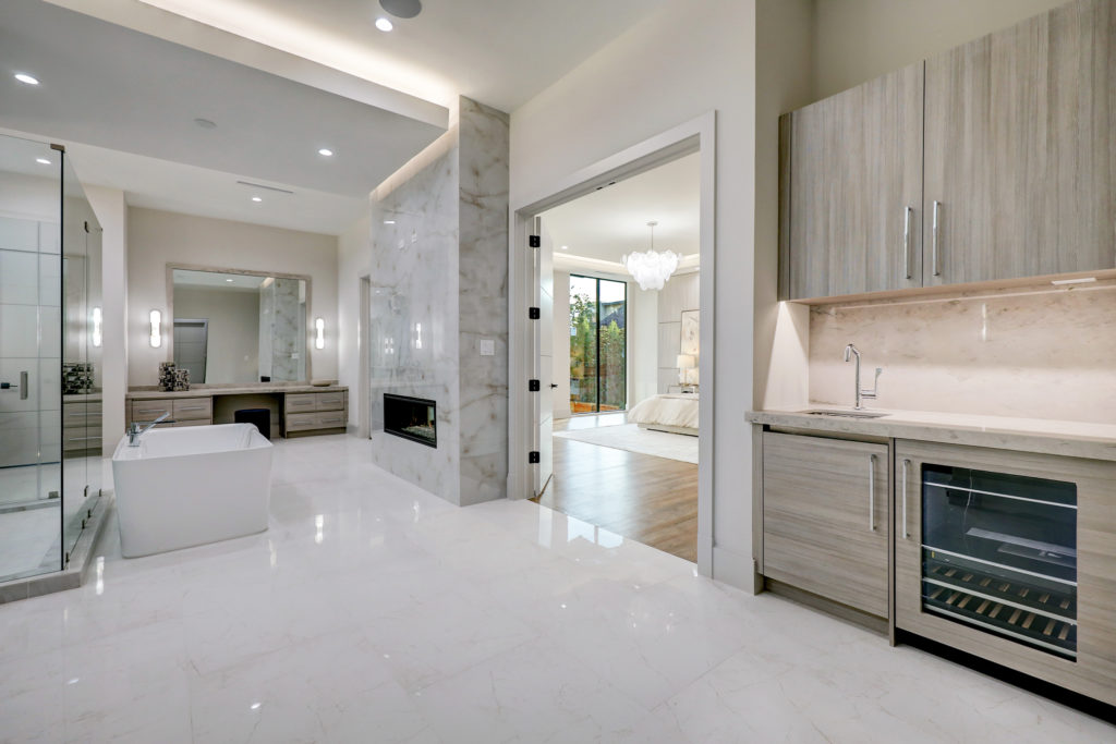 The double-sided fireplace at 275 Pine Hollow Lane heats both the master suite and master bath. (Photo by TK Images)