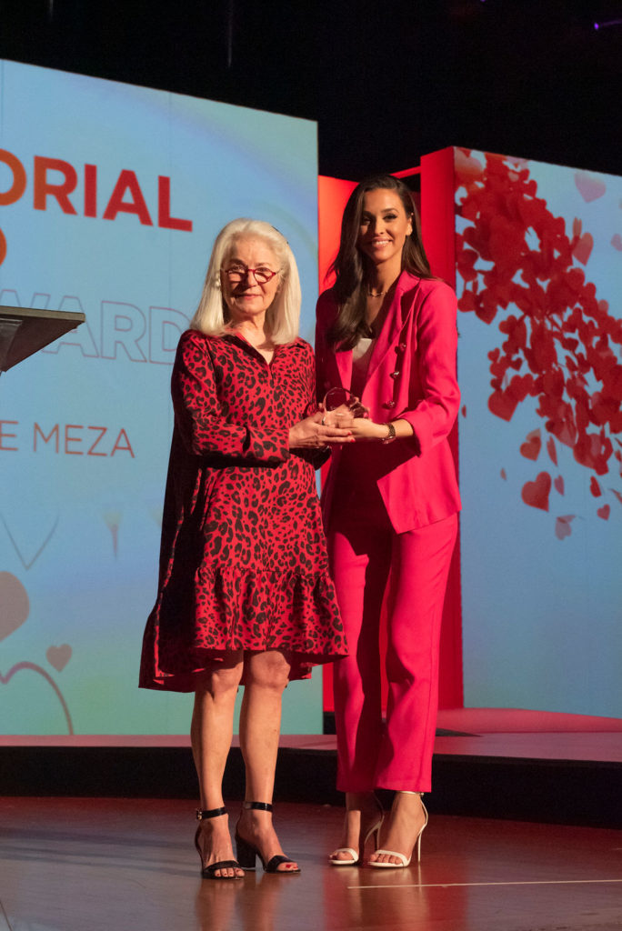 Teresa Meza accepting award for husband George Meza, 2023 Memorial Hero Award recipient
with emcee Hanna Battah (Photo by Tamytha Cameron)