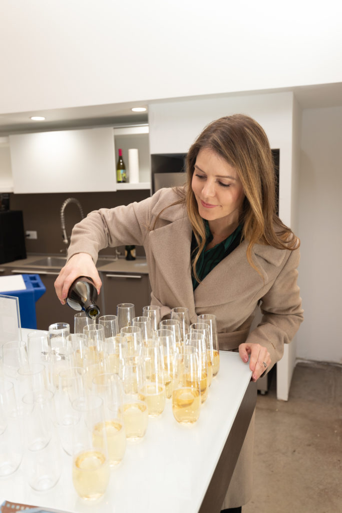 Uptown Dallas Inc., Meow Wolf, and Will Heron popped the bubbly to celebrate the new mural. (Photo by Exploredinary)