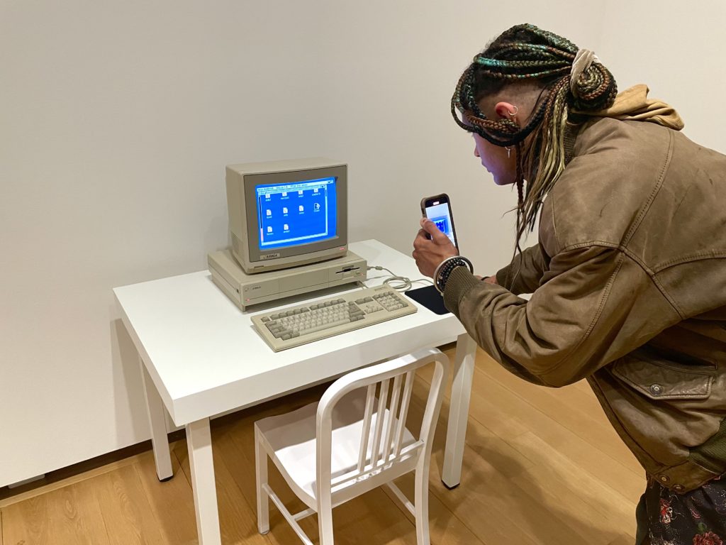 Artist Huntrezz Janos interacts with Andy2 by Andy Warhol where her artworks are also on display. (Photo by Courtney Dabney)