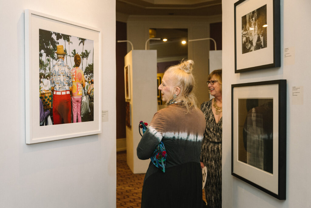 A guest observes Gay Block's "Miami, South Beach (my shadow on red pants)," 1982 at Houston Center for Photography's Print Auction & Dinner. (Photo by Johnny Than)