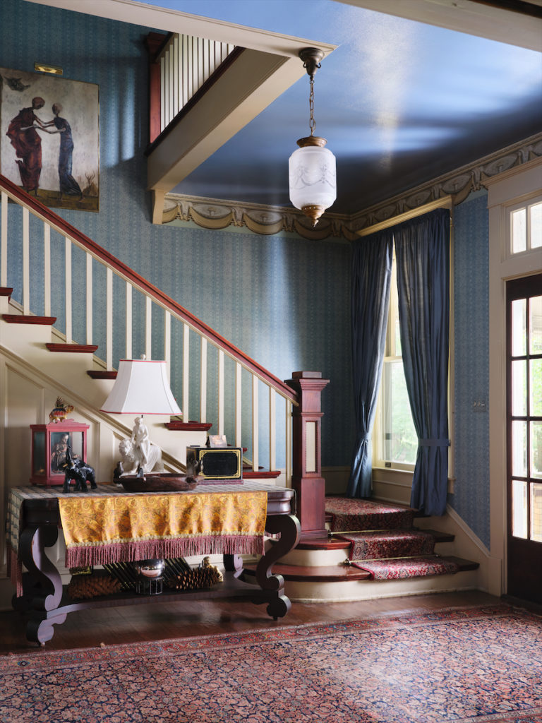 Morton added theatrical touches throughout the house, including the entryway with its celestial blue ceiling and upholstered swag border design. (Photo by Lisa Petrole)