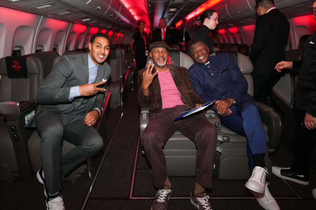 Ryan Hollins, Mario Ellie, Calvin Murphy aboard the team plane at the Houston Rockets Clutch City Foundation gala at the Landry's hangar at Hobby Airport.