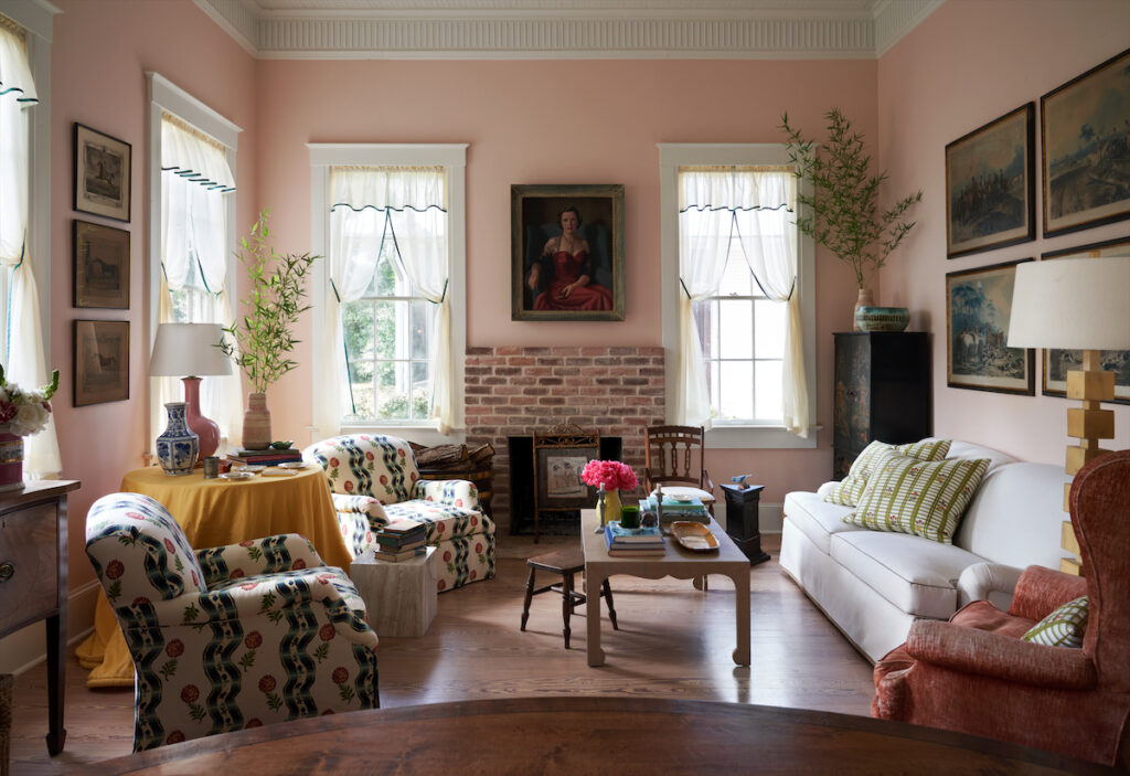 The living area was the train depot’s former waiting room. A pair of armchairs upholstered in Pierre Frey fabric. Portrait of Marie Lee Phelps. (Photo by PÄR BENGTSSON)