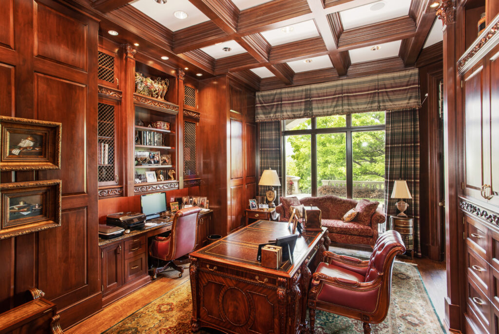 One of the home's offices with coffered ceilings and walnut walls.