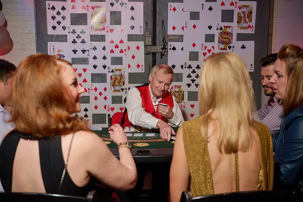 Guests try their luck at the casino table at Fresh Arts Thunder Ball. (Photo by Charlie Horse Photography)