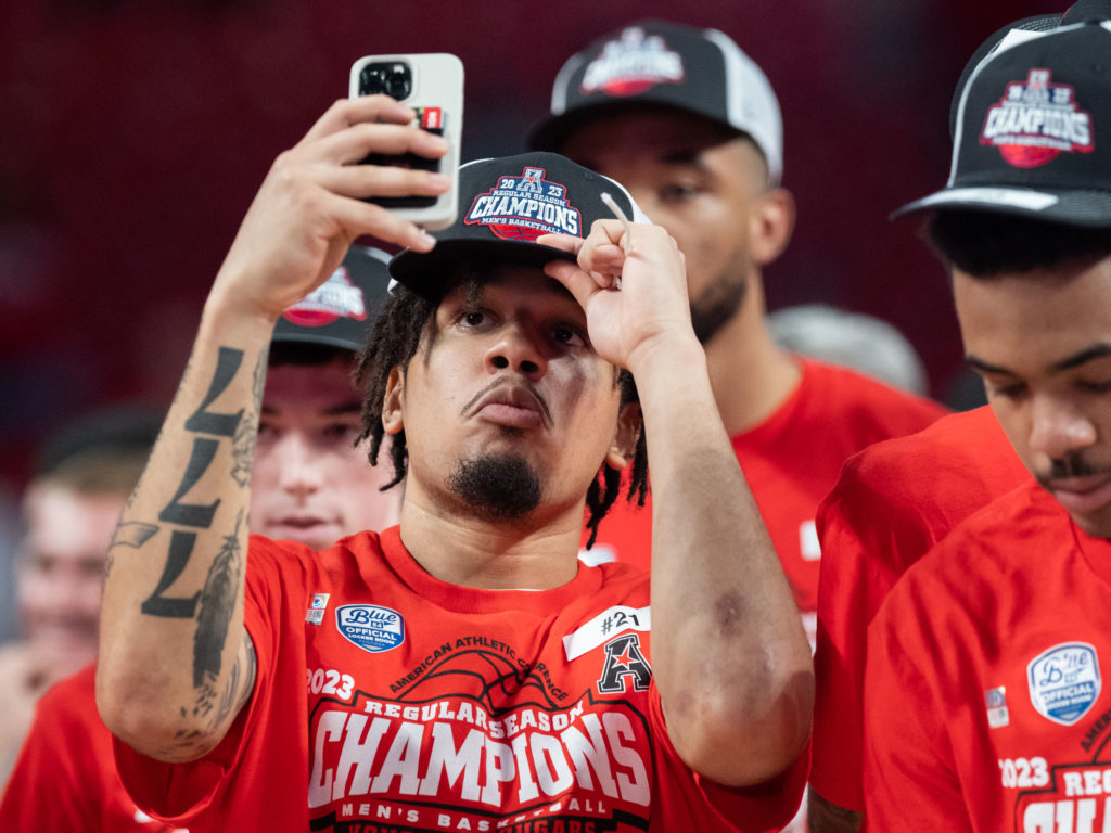 UH guard Emanuel Sharp knows earning a championship hat is worthy of a selfie. (Photo by F. Carter Smith)