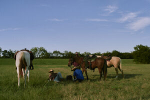 Cowboys resting in a field