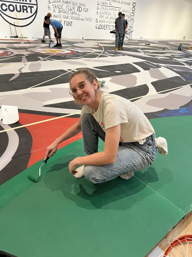 Museum preparator/Houston artist Iva Kinnaird wields a paintbrush for CAMH Court. (Photo by CDA) 