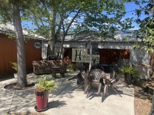 The back patio at H-Wines is shaded and quiet for a peaceful wine drinking experience.