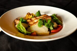 PS-21 serves both the traditional seafood bouillabaisse as well as this vegan version. (Photo by Interiors: Raydon Creative, Food and Drink: Harold Cua)