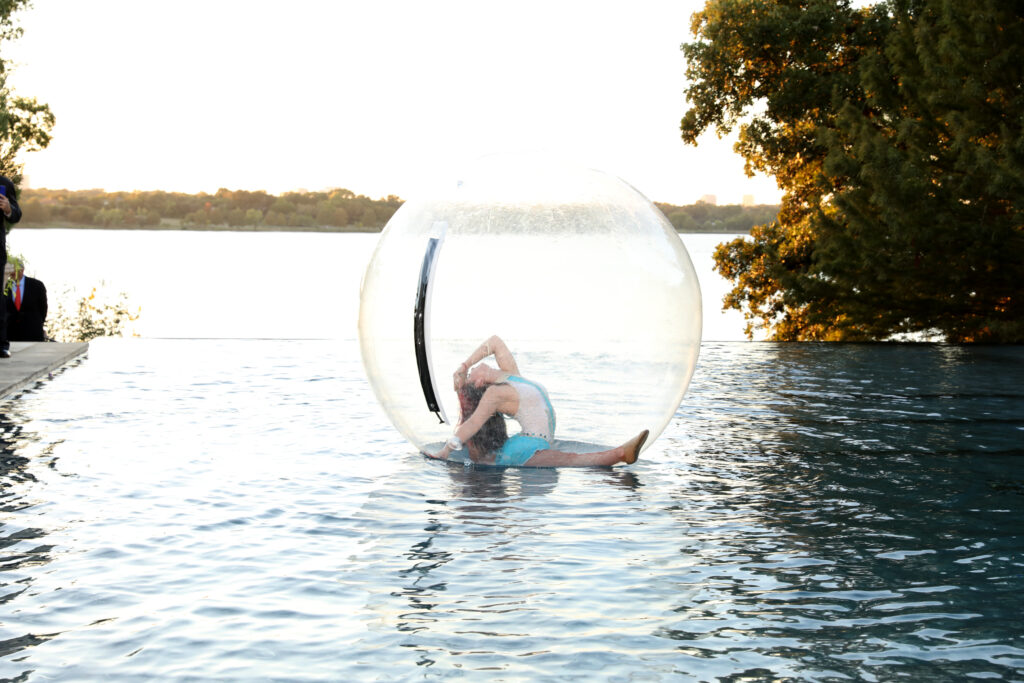 Bubble acrobat performing on the Infinity Pool in A Woman’s Garden (Photo by Danny Campbell and Rob Wythe/Wythe Portrait Studio)