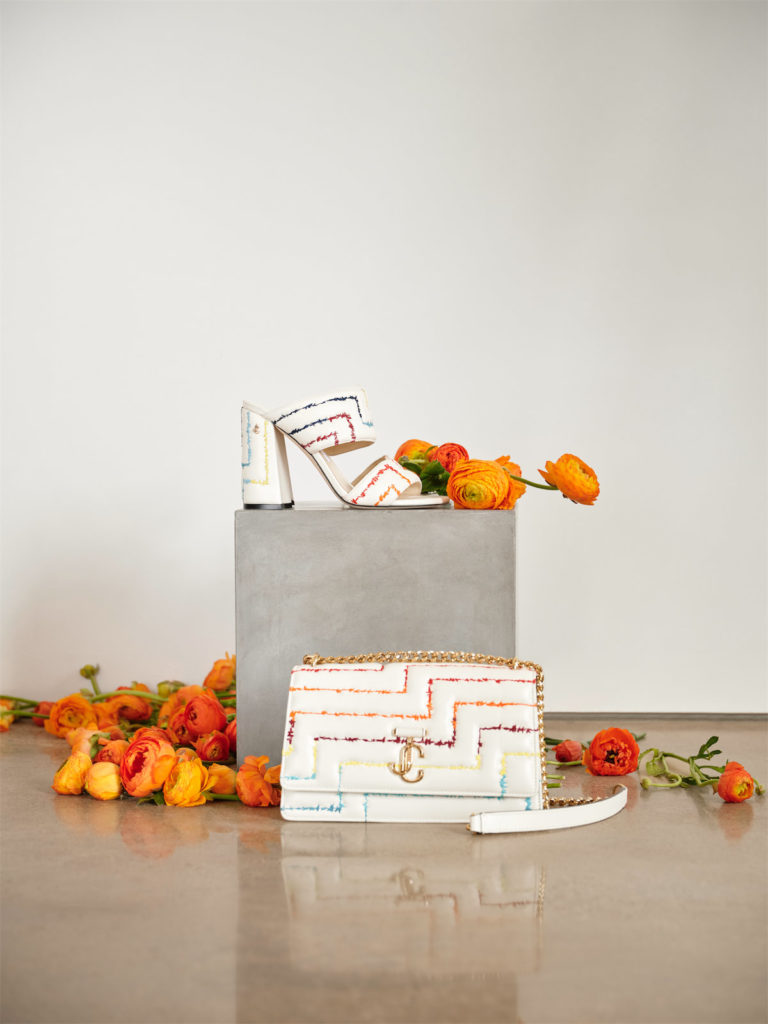 Both Jimmy Choo signatures, the Varenne Avenue shoulder bag, and the Themis Sandal 100 are enriched with rainbow embroidery in the iconic matelassé pattern.