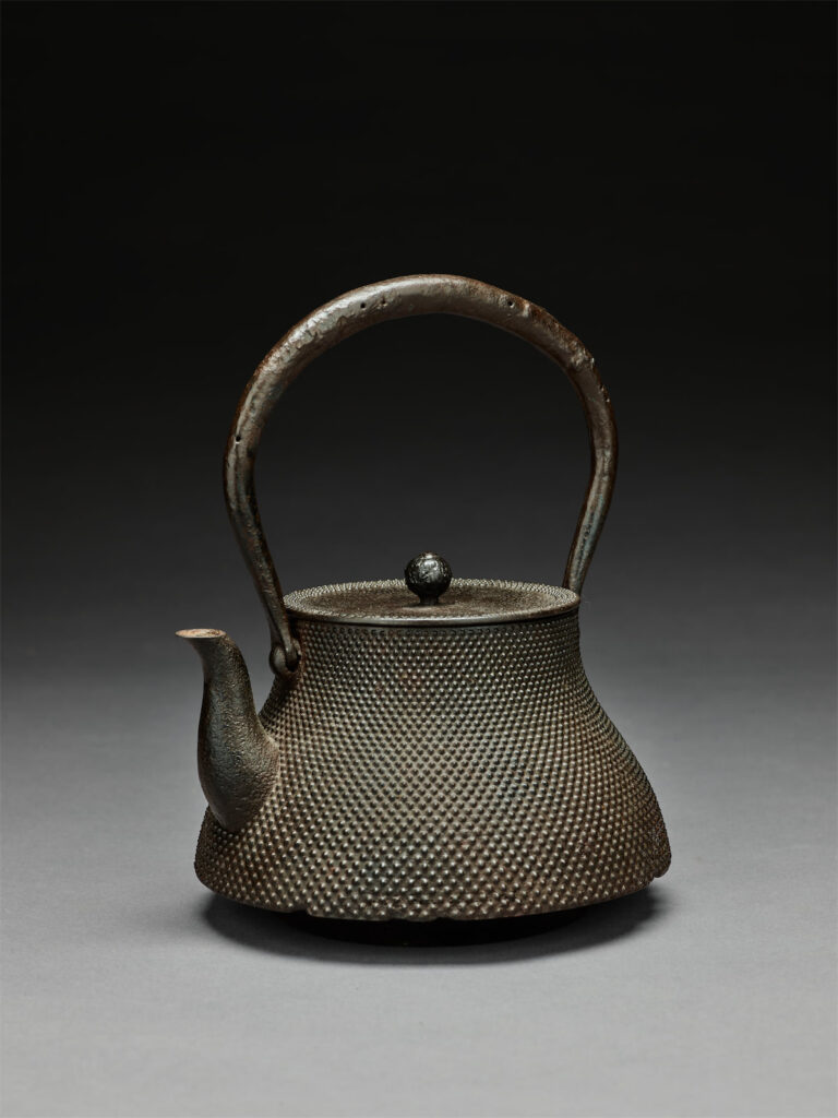 Tea kettle with hailstone pattern. Meiji period, early 20th century. Nanbu area, Iwate prefecture. Cast and patinated iron with wrought iron handle. (Photo by Chadwick Redmon)