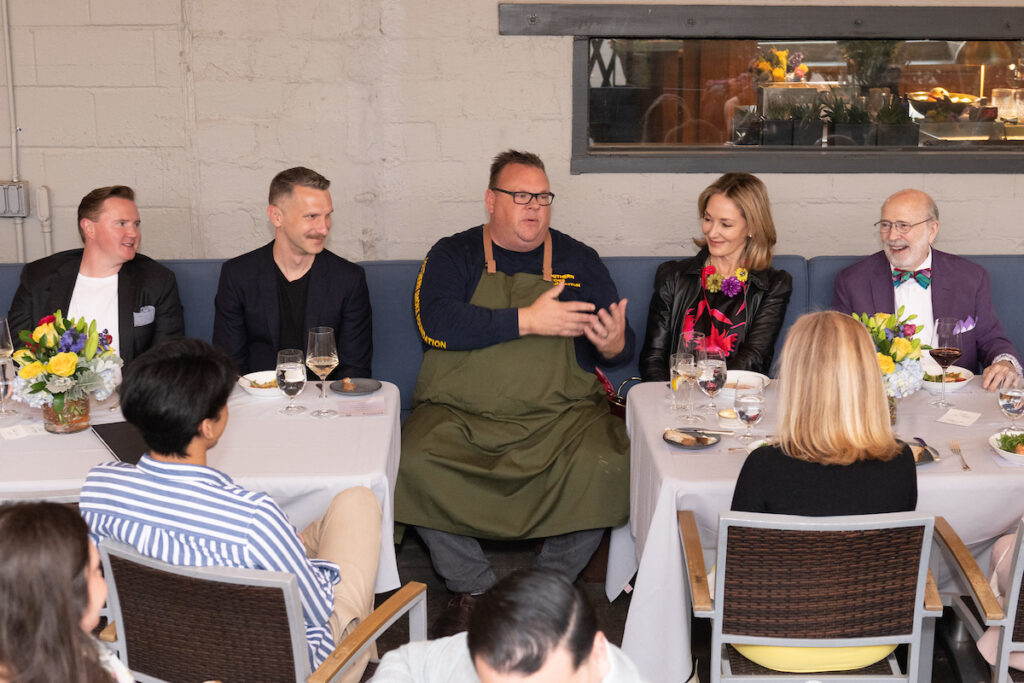 Chef Chris Shepherd discusses the inspiration behind his king salmon dish with guests at Houston Ballet's Raising the Barre dinner fundraiser.  (Photo by Wilson Parish)