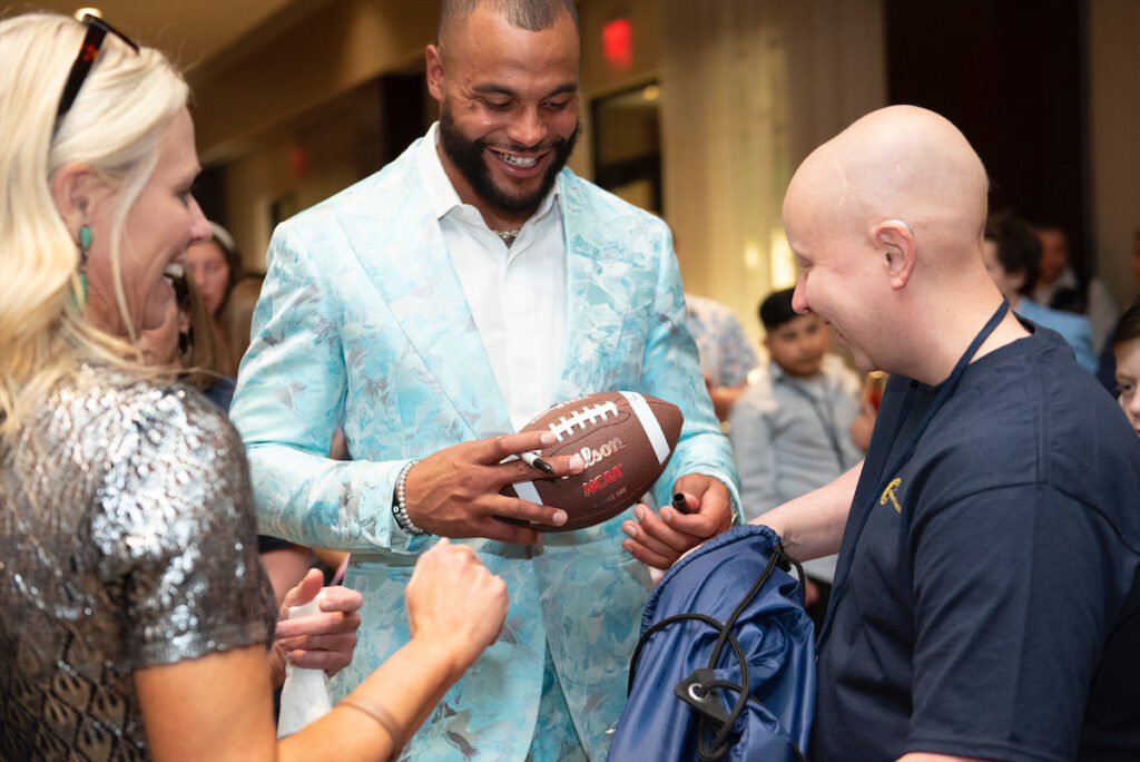 Dak Prescott and Volunteer (Photo by BFA and Tamytha Cameron)