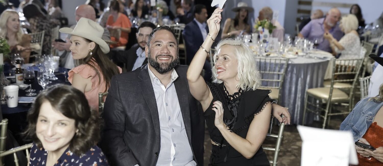 Guests bidding during the live auction (Photo by Quy Tran)