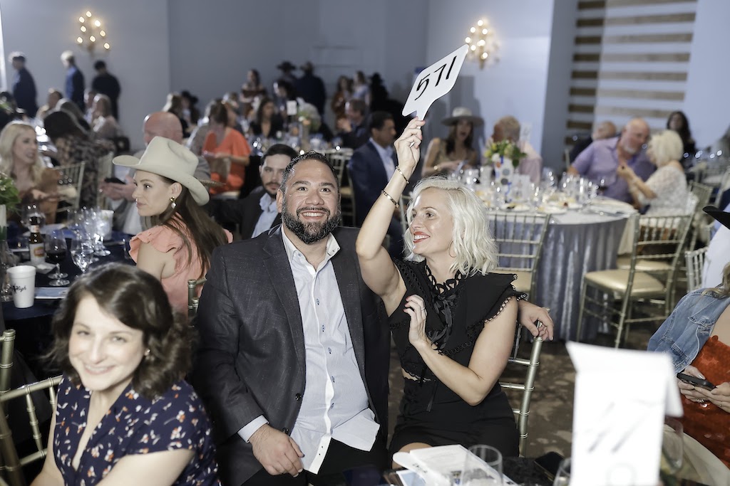 Guests bidding during the live auction (Photo by Quy Tran)
