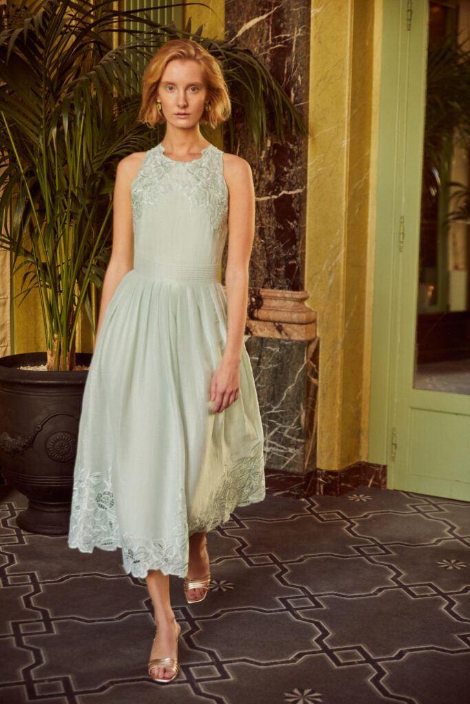 Created in the perfect shade of seafoam green, the Valerie midi dress features a high neckline, embroidered detailing, and fitted waistline.