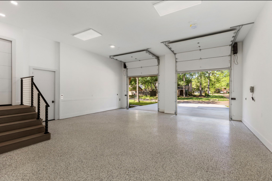 The garages at this Woodlands home have extended height in the ceilings and an epoxy floor.