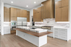 A multi-level island in the kitchen with modern surfaces helps set 114 S. Timber Top in Grogan’s Mill apart. (Photo by Engage Realty Media)