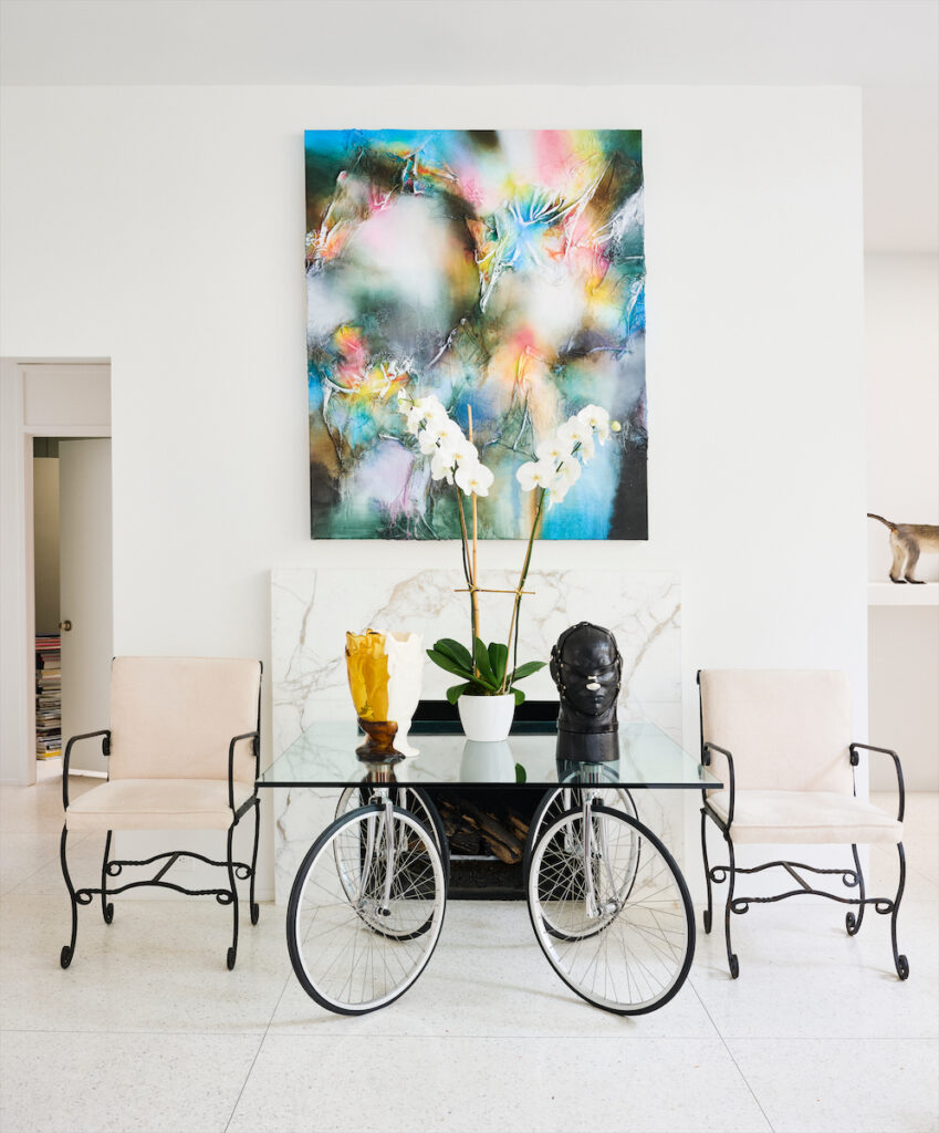 Painting by Leslie Martinez. Table by Gae Aulenti. Vessel by Gaetano Pesce, leather head by Nancy Grossman. Iron 1960s chairs from 1stDibs. (Photo by Jack Thompson)