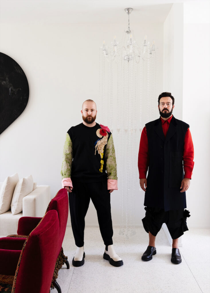 Cody Fitzsimmons and Christopher Scott. Chandelier sculpture by Kayode Ojo. (Photo by Jack Thompson)