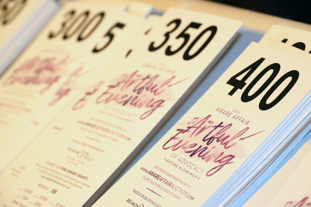 Bidder cards with logo (Photo by Lisa Stewart and Rob Wythe/Wythe Portrait Studio)