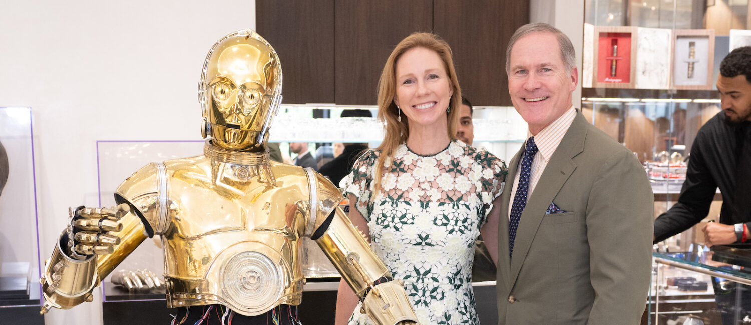 C-3PO, R2-D2, Kimberly and James Bell make the scene at the Valobra Star Wars exhibit. (Photo by Wilson Parish)