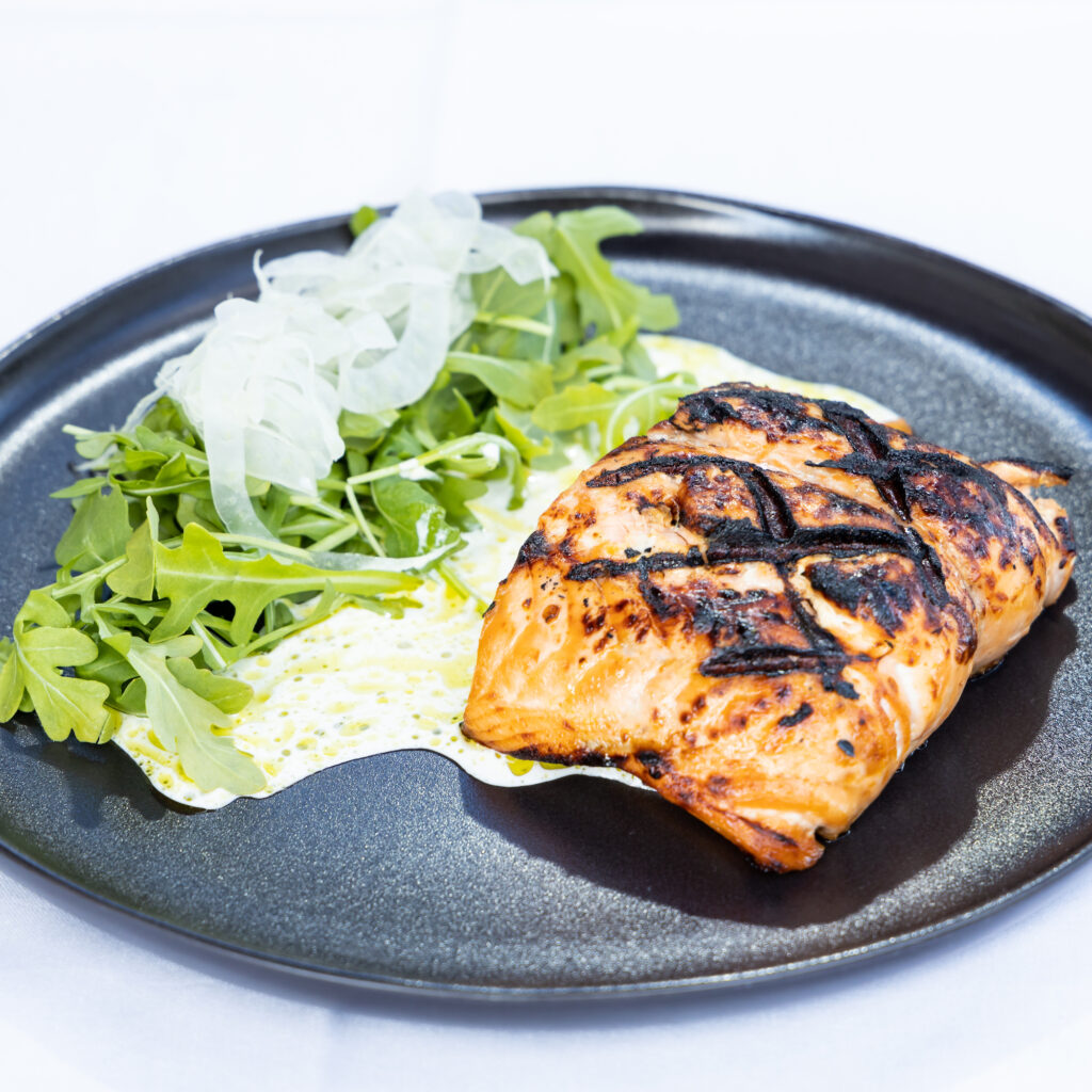 Main dishes include proteins like salmon with a side of arugula and fennel topped with house dill dressing. (Photo by Bear Media Co.)