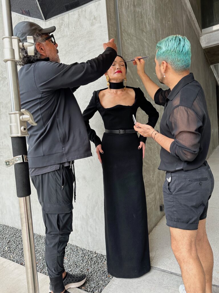 Ceron and Juan Peralta provide finishing touches for PaperCity Philanthropy in Fashion honoree Duyen Huynh Nguyen.