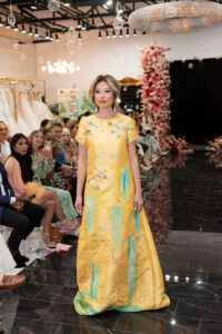 Lea Caprice in a yellow adorned gown from the collection (Photo by Celeste Cameron)