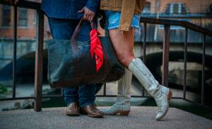 Love Collection – Denim shirt, mens dark boot cut jean, canvas trucker jacket, weekender bag, and red bandana. (Photo by Daniel Hooks)