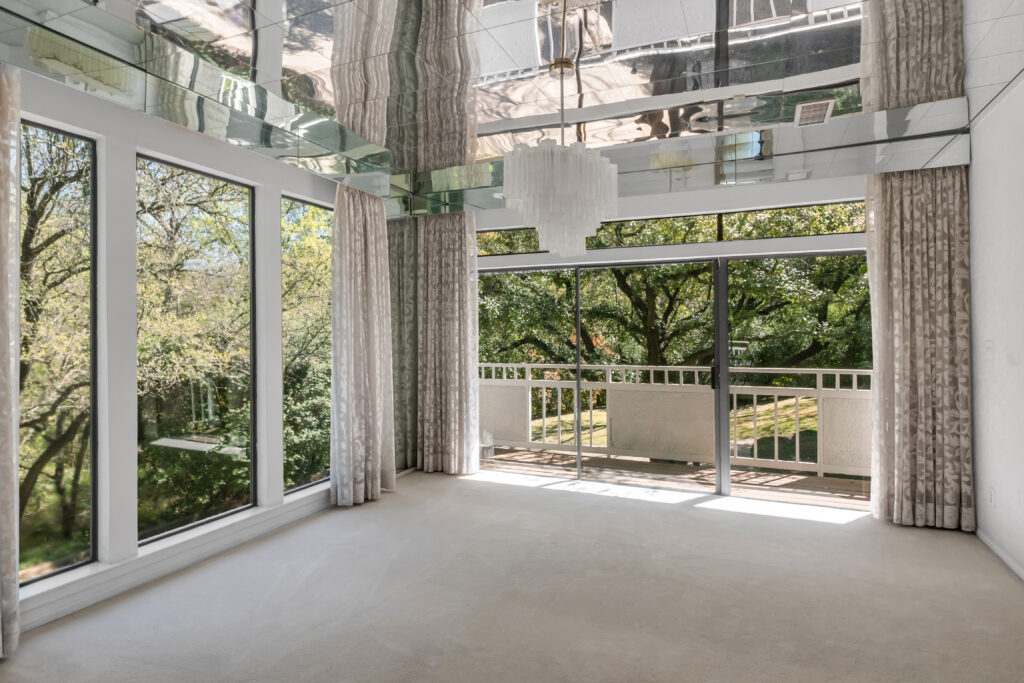 A peek at the mirrored ceiling in the dining room with its modern chandelier.