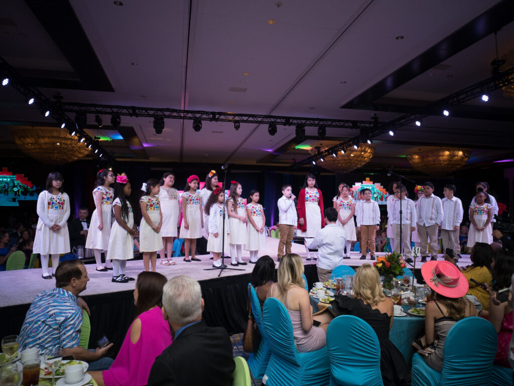 The Segundo Barrio Children's Chorus performs at the Latin Women's Initiative fashion show and luncheon. (Photo by Daniel Ortiz)