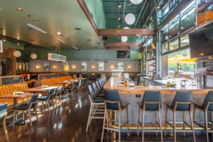 Southlake – Postino – Booths, bar seating and and couches give Postino Woodlands diners plenty of room to relax. (Photo by Jenn Duncan)