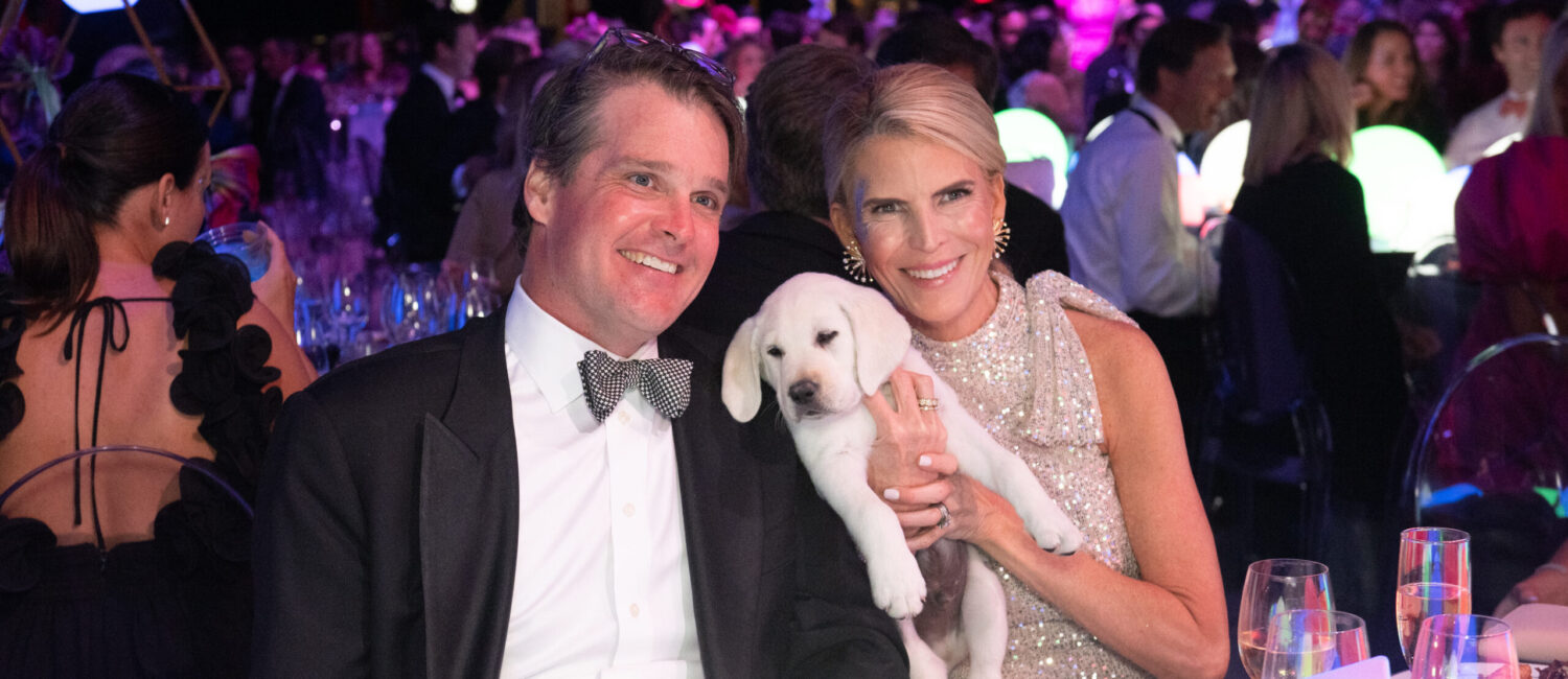 Amy & Leyton Woolf snuggle their puppy, Henri, as they were top bidders in The Children's Fund gala auction (Photo by Wilson Parish)