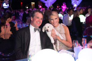 Amy & Leyton Woolf snuggle their puppy, Henri, as they were top bidders in The Children's Fund gala auction (Photo by Wilson Parish)