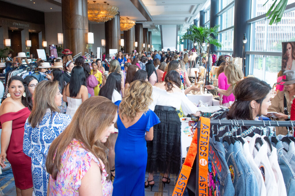 Marketplace shopping in the foyer of the Hilton Americas-Houston during the Latin Women's Initiative fashion show and luncheon. (Photo by Jacob Power)