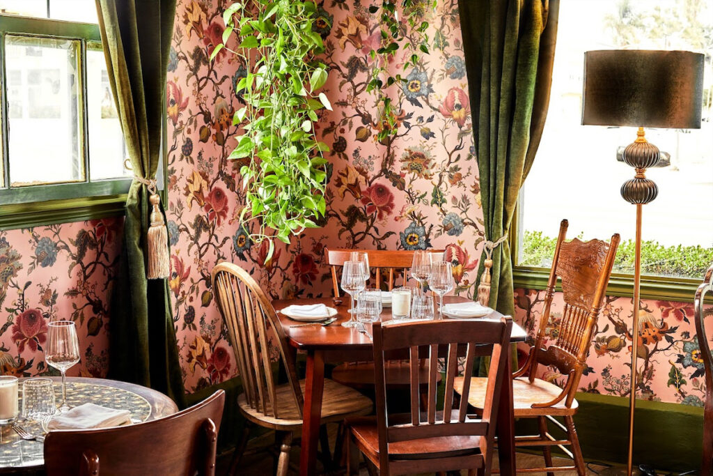 Dine within Cobi’s lush, wall-papered walls. 