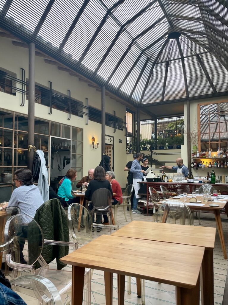 Main dining room of Prudencia, under an iron and glass canopy designed by Simón Vélez (Photo by Cole Von Feldt)