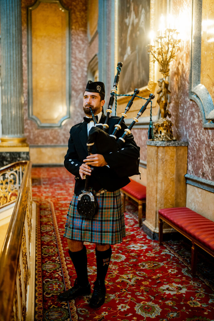 A bagpiper at Lancaster House in London signals the dinner hour at the Skylar Pinchal and Oliver Coysh wedding celebration.